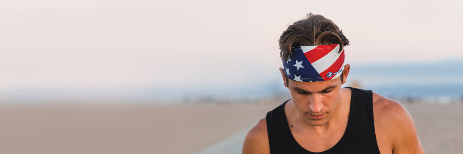 Guy walking on the beach with a Suddora USA flag headband