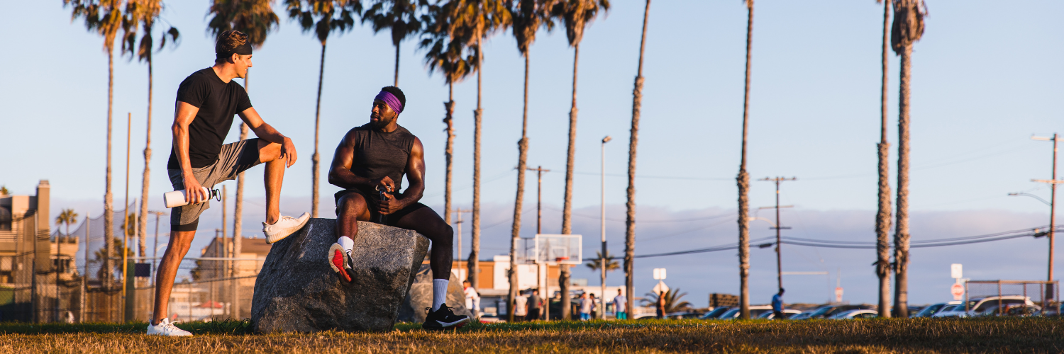 Two men wearing Suddora headbands talking after working out