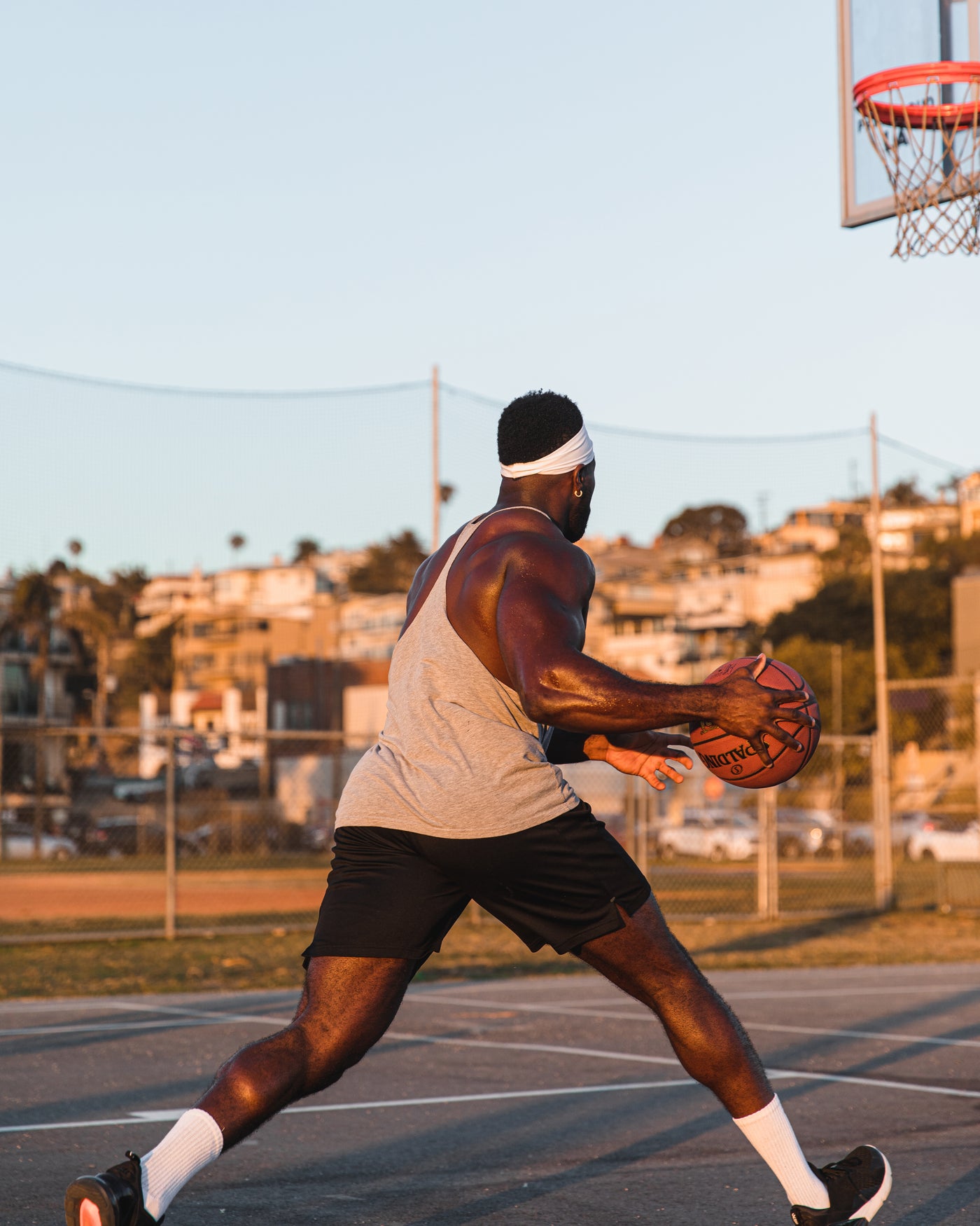 Athlete playing basketball in the park