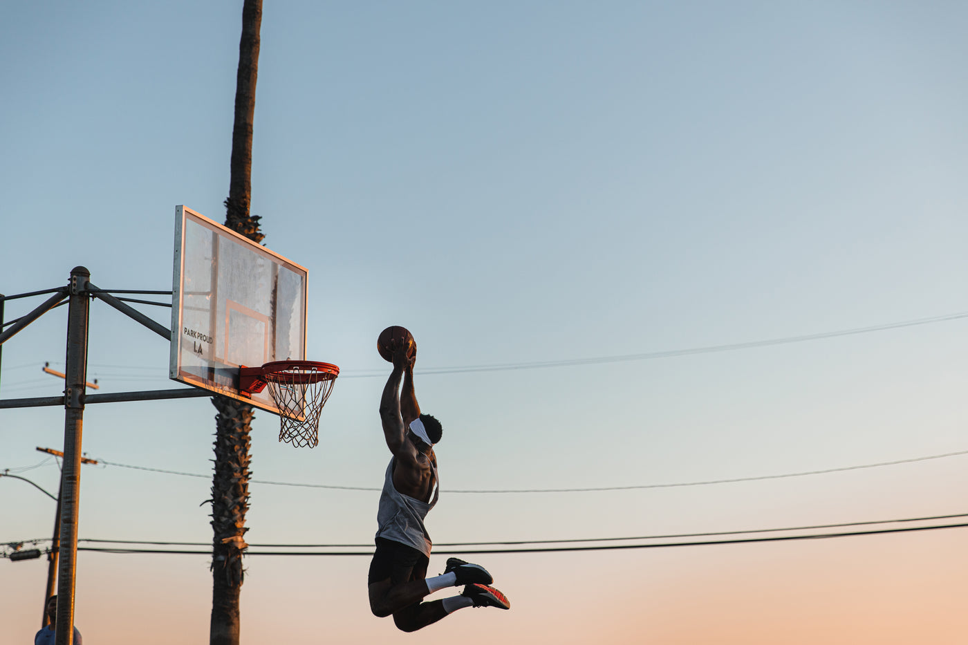 Basketball player dunking with Suddora Headband on